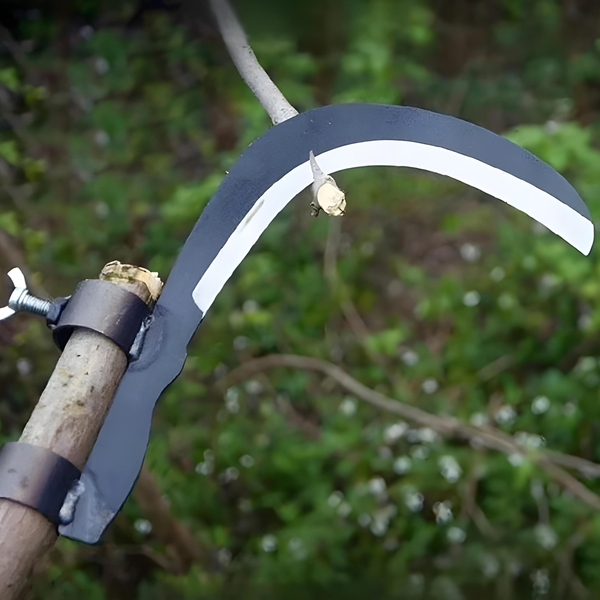 Garden tool with curved blade and wooden handle against a blurred green background