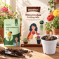A gardening product set on a wooden surface with potted flowers in the background. The set includes a bag of Paankhuri Ranunculus Potting Mix, a package of Paankhurii Imported Ranunculus Bulbs, a small white pot filled with soil and a bulb, and scattered potting soil with a small trowel.